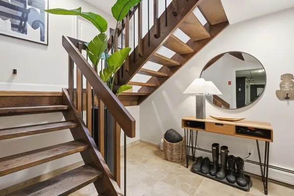 a view of entryway and hall with wooden floor