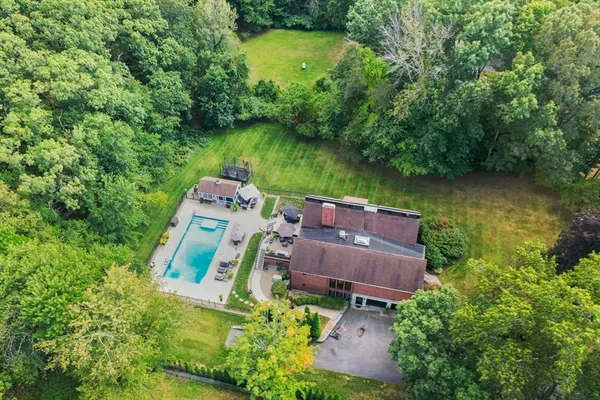 an aerial view of a house with a yard basket ball court and outdoor seating