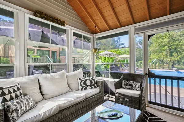 a living room with furniture and a floor to ceiling window