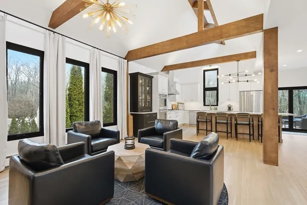 a living room with furniture and large windows