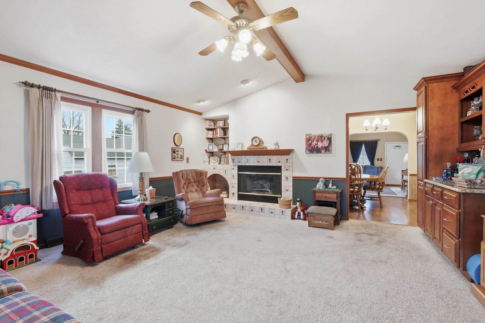 1806 41st Street Moline, IL 61265 - Photo 12 of 35 a living room with furniture a fireplace and a large window