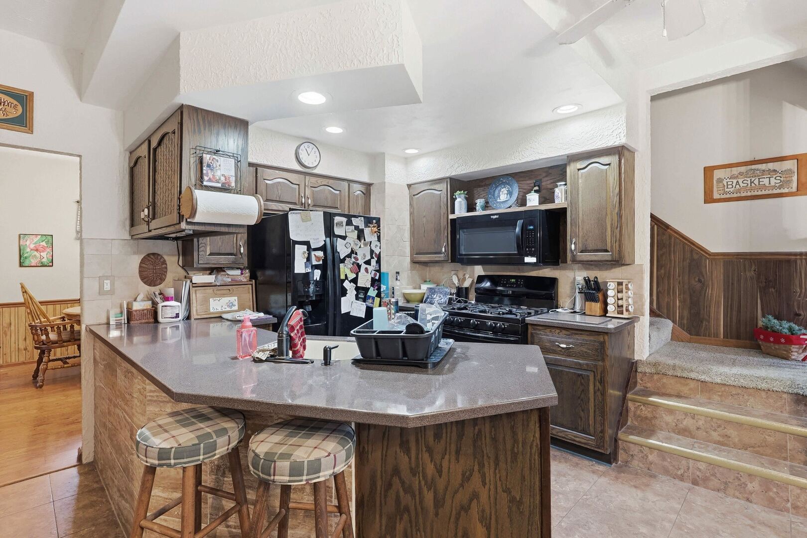 1806 41st Street Moline, IL 61265 - Photo 16 of 35 a kitchen with stainless steel appliances kitchen island granite countertop a sink and a refrigerator