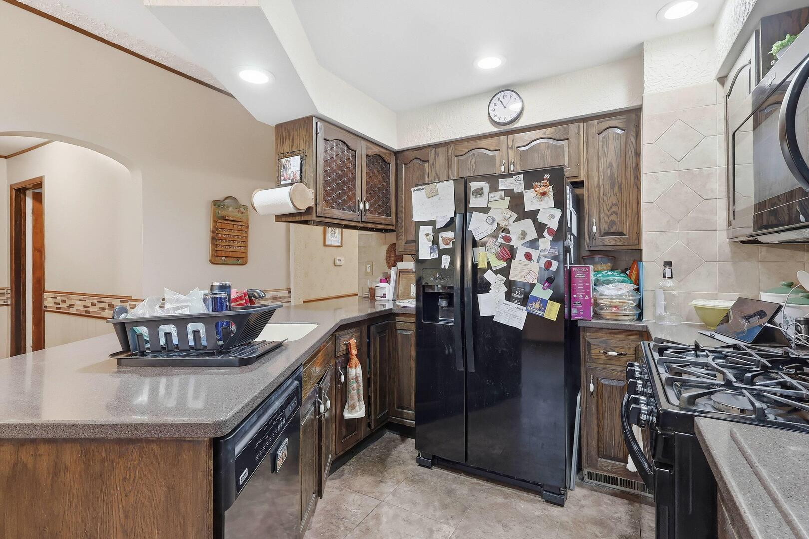 1806 41st Street Moline, IL 61265 - Photo 18 of 35 a kitchen with stainless steel appliances granite countertop a stove and cabinets