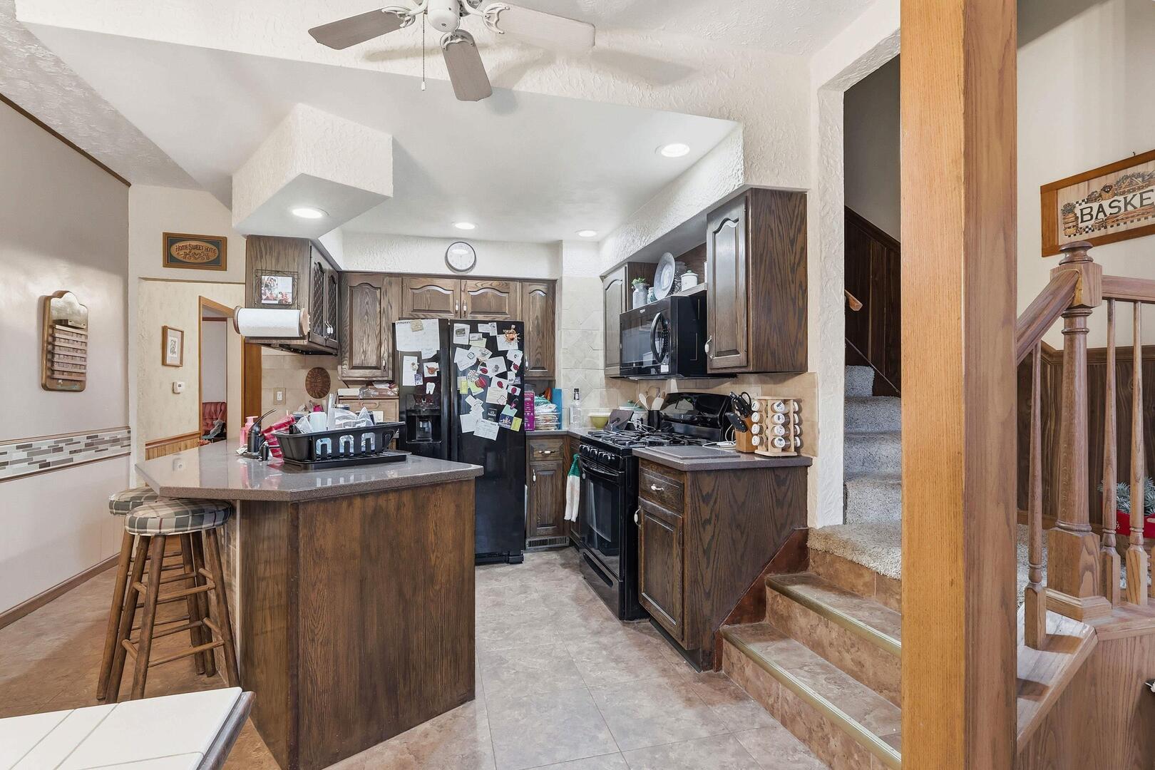 1806 41st Street Moline, IL 61265 - Photo 19 of 35 a kitchen with stainless steel appliances kitchen island granite countertop a stove refrigerator and cabinets