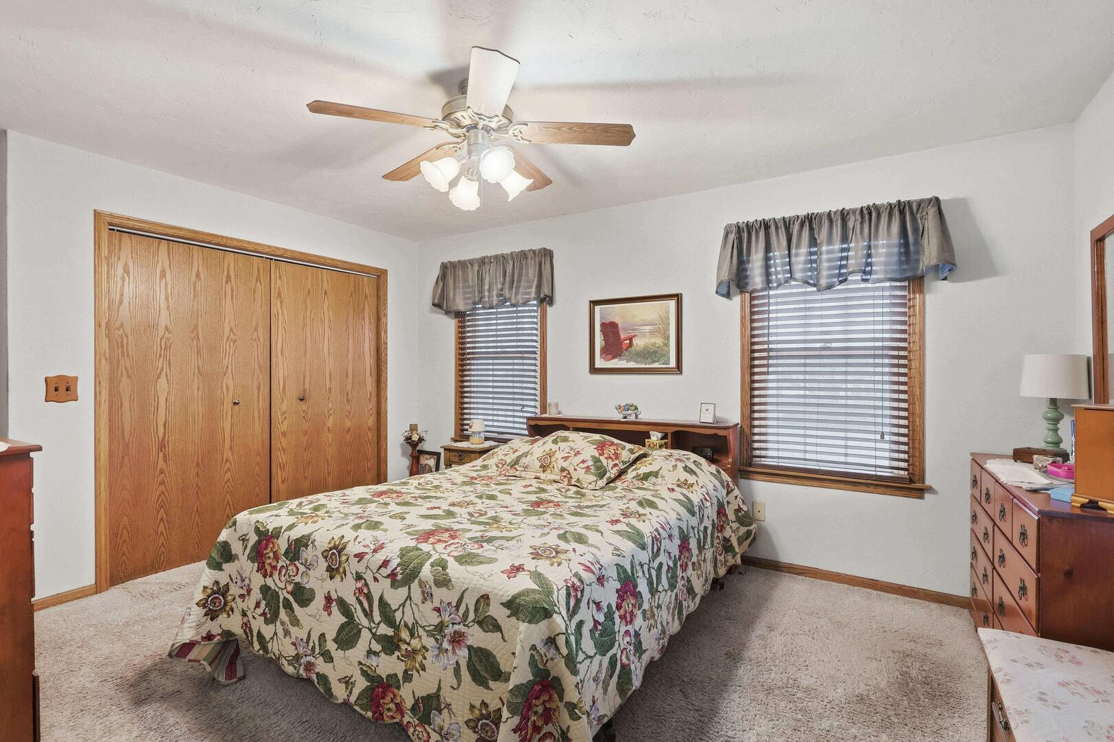 1806 41st Street Moline, IL 61265 - Photo 20 of 35 a bedroom with a bed and a chandelier