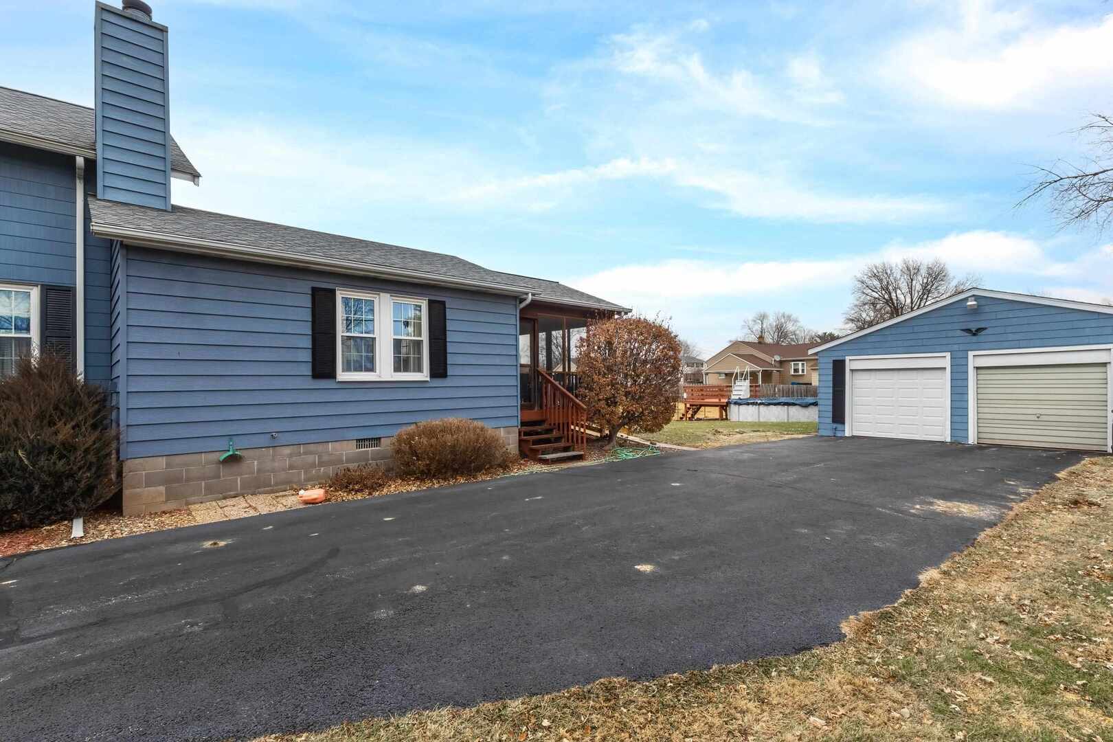 1806 41st Street Moline, IL 61265 - Photo 31 of 35 a front view of a house with a yard and garage