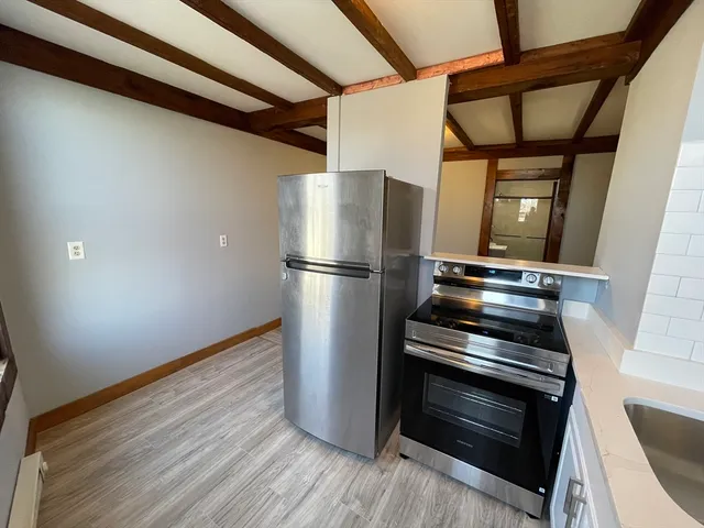 a view of kitchen with a refrigerator wooden floor and stair