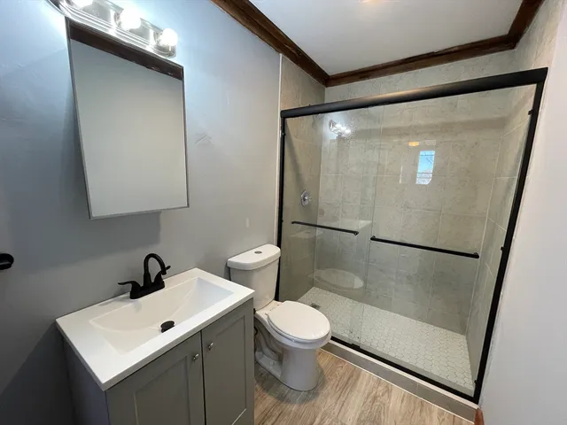 a bathroom with a sink mirror toilet and shower
