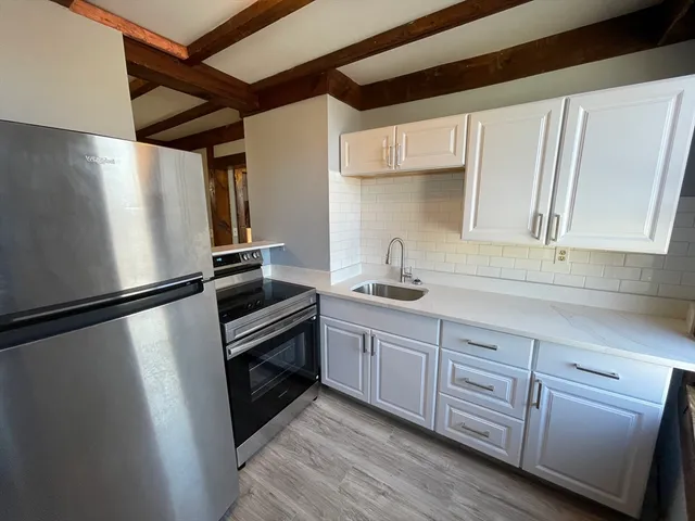 a kitchen with cabinets and stainless steel appliances