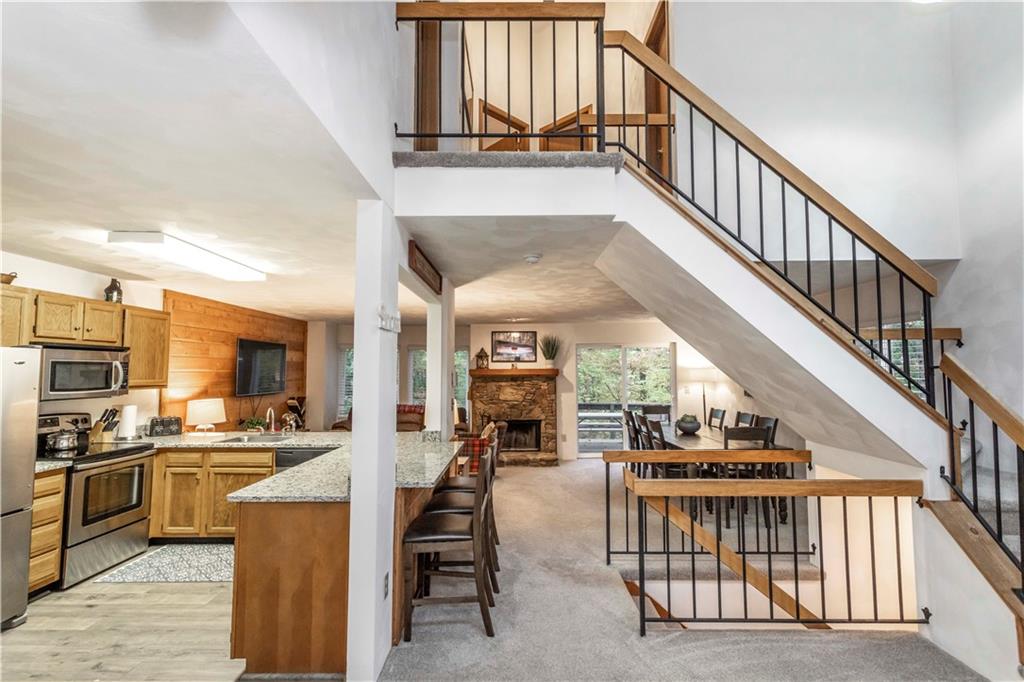 1821 Eagles Ridge Terrace Hidden Valley, PA 15502 - Photo 3 of 49 a view of kitchen and dining room with wooden floor and electronic appliances