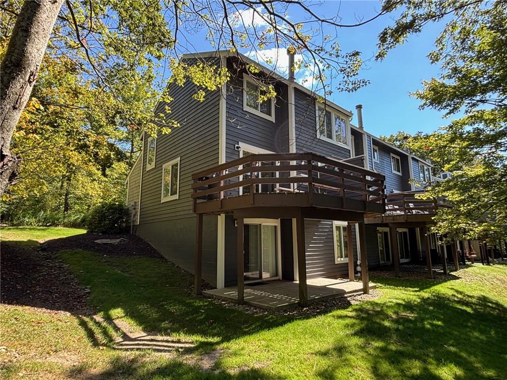 1821 Eagles Ridge Terrace Hidden Valley, PA 15502 - Photo 40 of 49 a view of a brick house with a large windows and a large tree