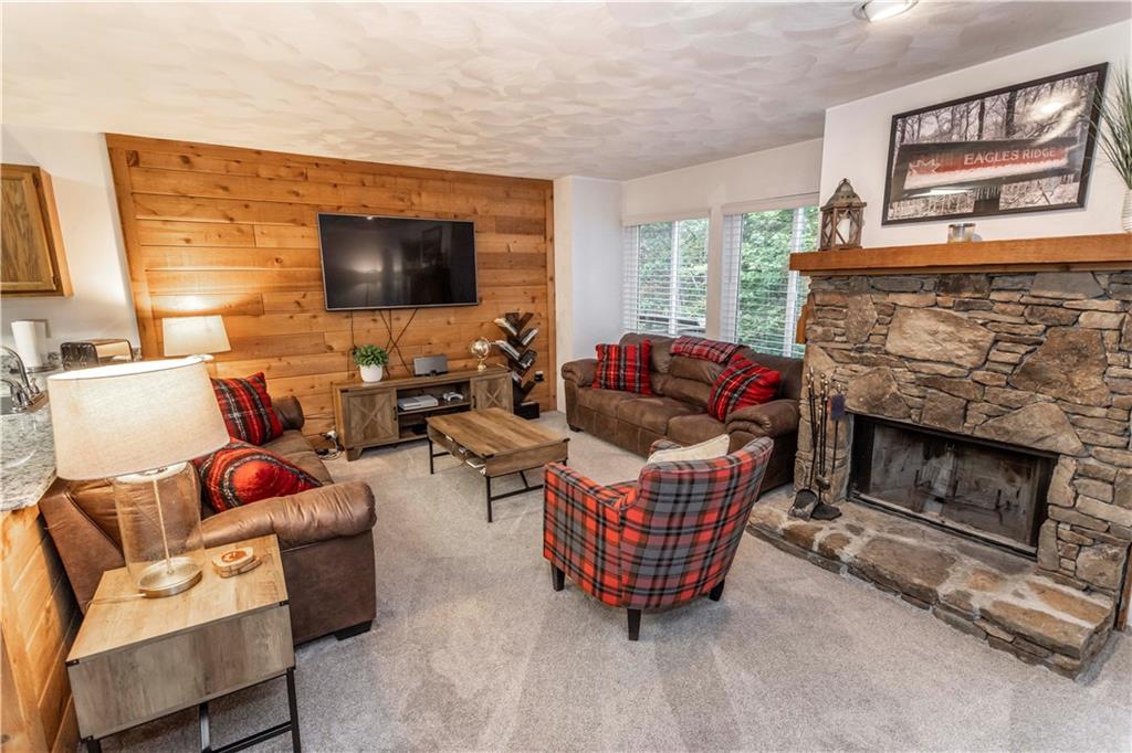 1821 Eagles Ridge Terrace Hidden Valley, PA 15502 - Photo 4 of 49 a living room with furniture a flat screen tv and a fireplace