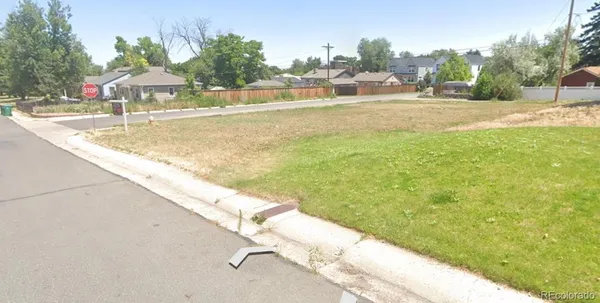 a view of swimming pool with lawn chairs and plants