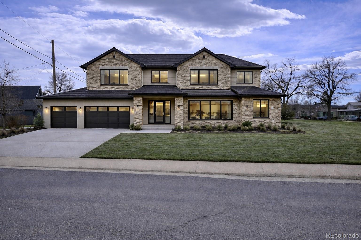 3292 Benton Street Wheat Ridge, CO 80212 - Photo 3 of 12 a front view of a house with a yard