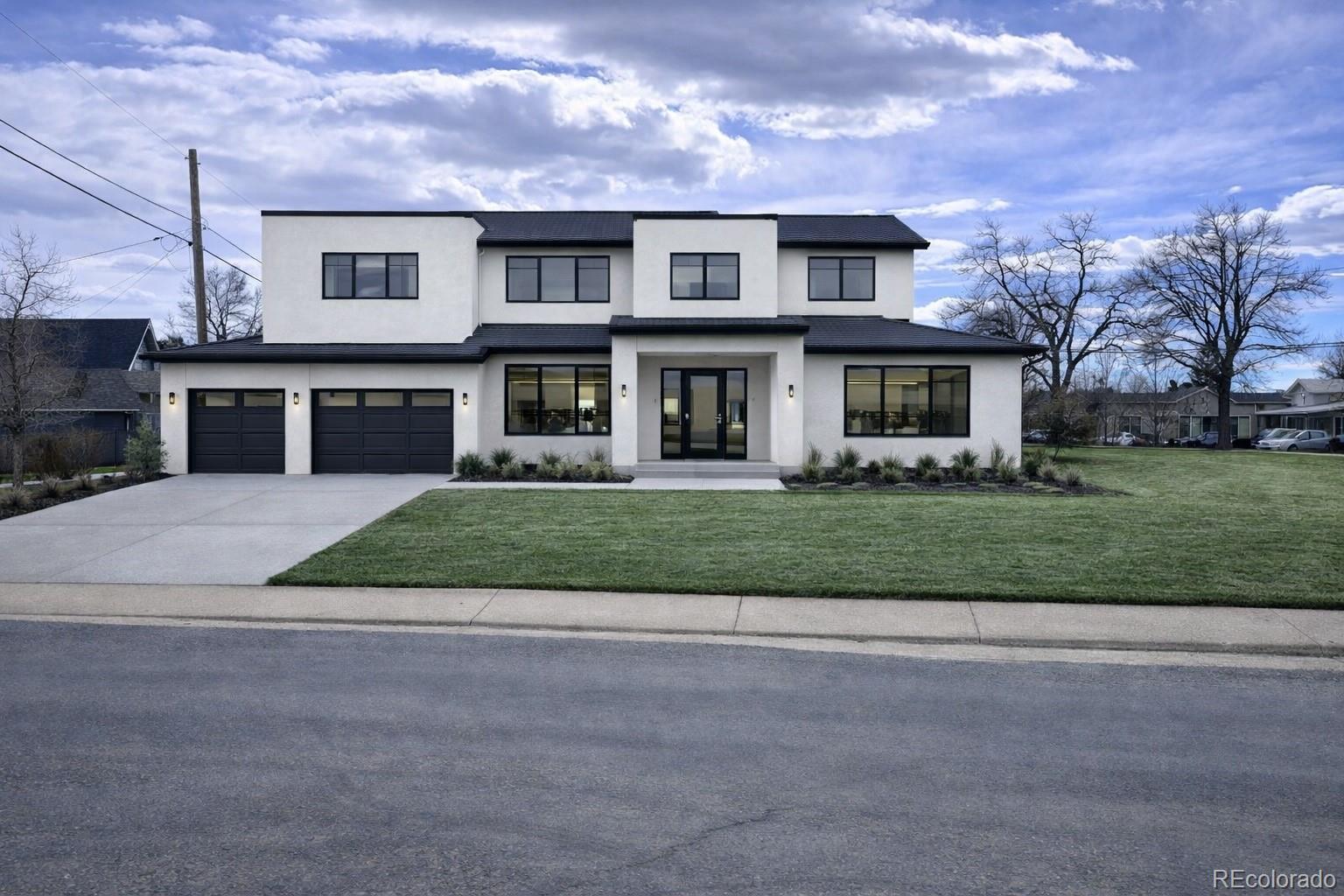 3292 Benton Street Wheat Ridge, CO 80212 - Photo 5 of 12 a front view of a house with a yard