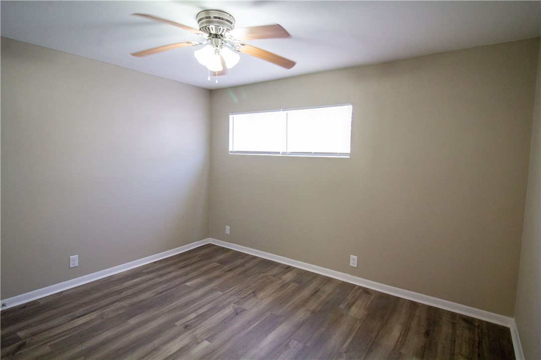 1804 North McKinley Street Beeville, TX 78102 - Photo 11 of 15 wooden floor in an empty room with a window