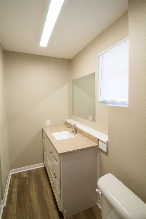 1804 North McKinley Street Beeville, TX 78102 - Photo 12 of 15 a bathroom with a sink a toilet and a mirror
