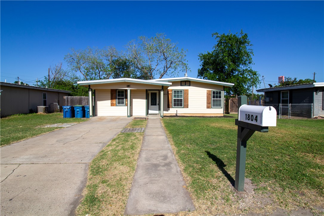 1804 North McKinley Street Beeville, TX 78102 - Photo 2 of 15 a front view of a house with a yard and trees