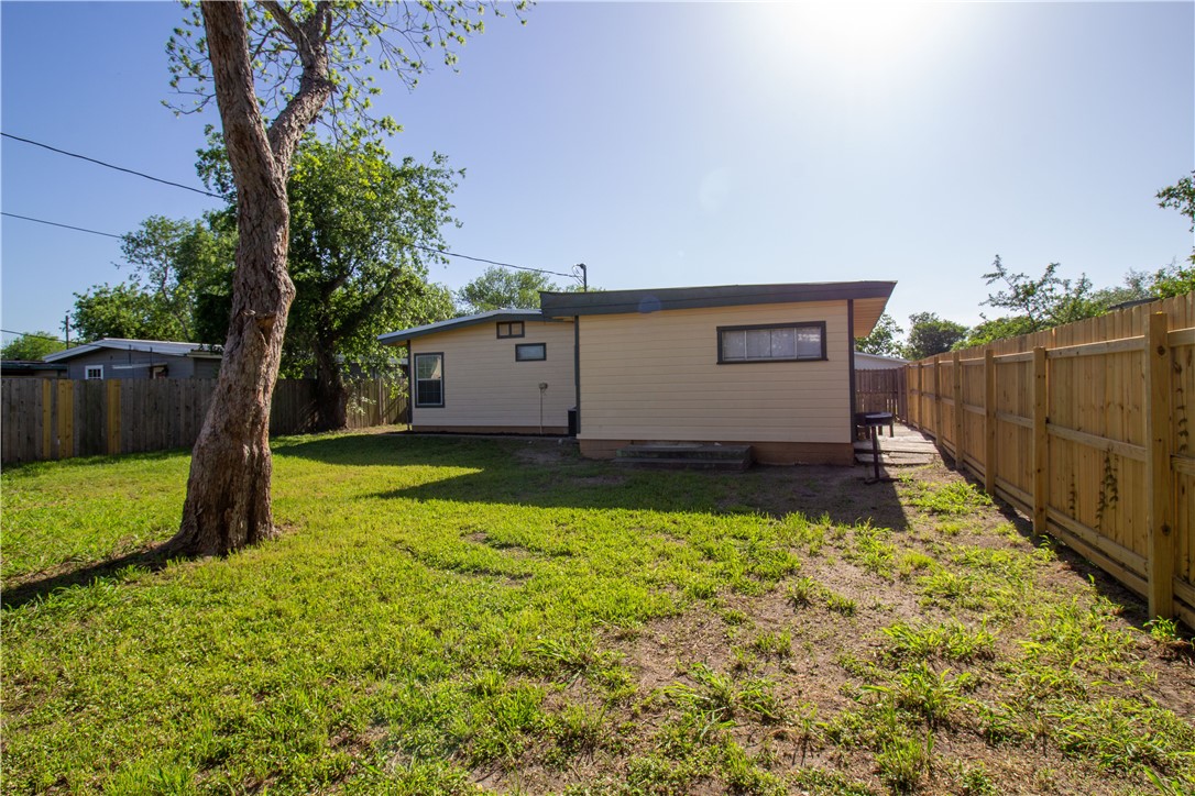 1804 North McKinley Street Beeville, TX 78102 - Photo 5 of 15 a view of backyard with wooden fence and a large tree