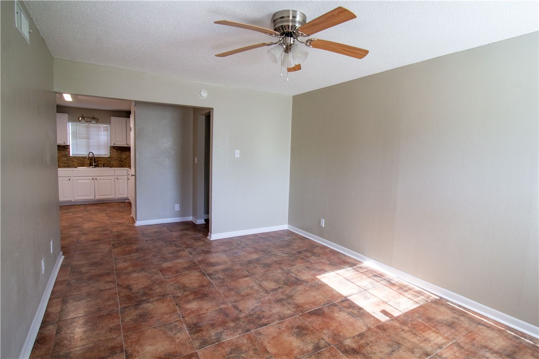 1804 North McKinley Street Beeville, TX 78102 - Photo 6 of 15 a view of a kitchen with a sink and a refrigerator