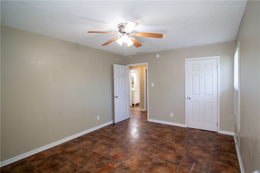1804 North McKinley Street Beeville, TX 78102 - Photo 9 of 15 an empty room with closet and a chandelier fan