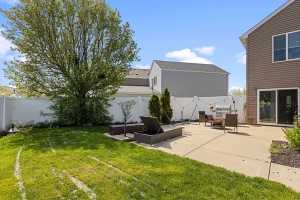 a view of a backyard with a sitting area and furniture