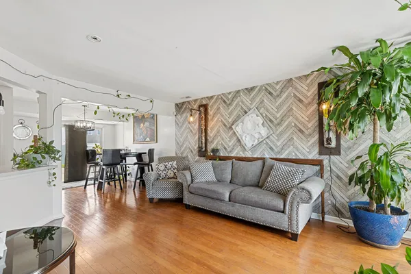 a living room with furniture and wooden floor