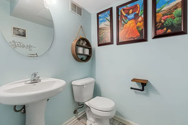 a bathroom with a toilet a sink and a mirror