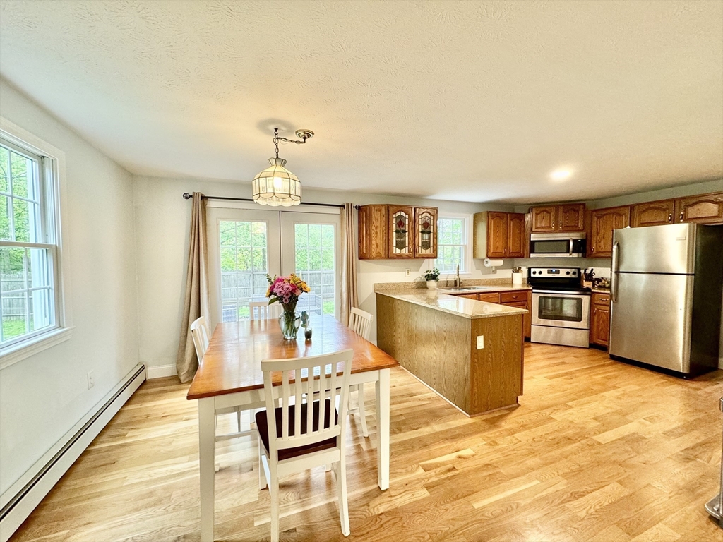 29 Whitewood Road Groton, MA 01450 - Photo 17 of 38 a kitchen with stainless steel appliances granite countertop a stove top oven a sink dishwasher and a refrigerator