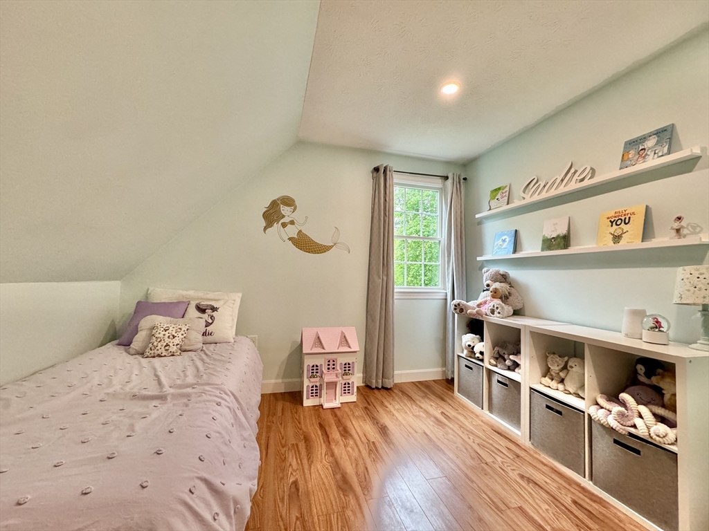 29 Whitewood Road Groton, MA 01450 - Photo 26 of 38 a bedroom with furniture and a wooden floor