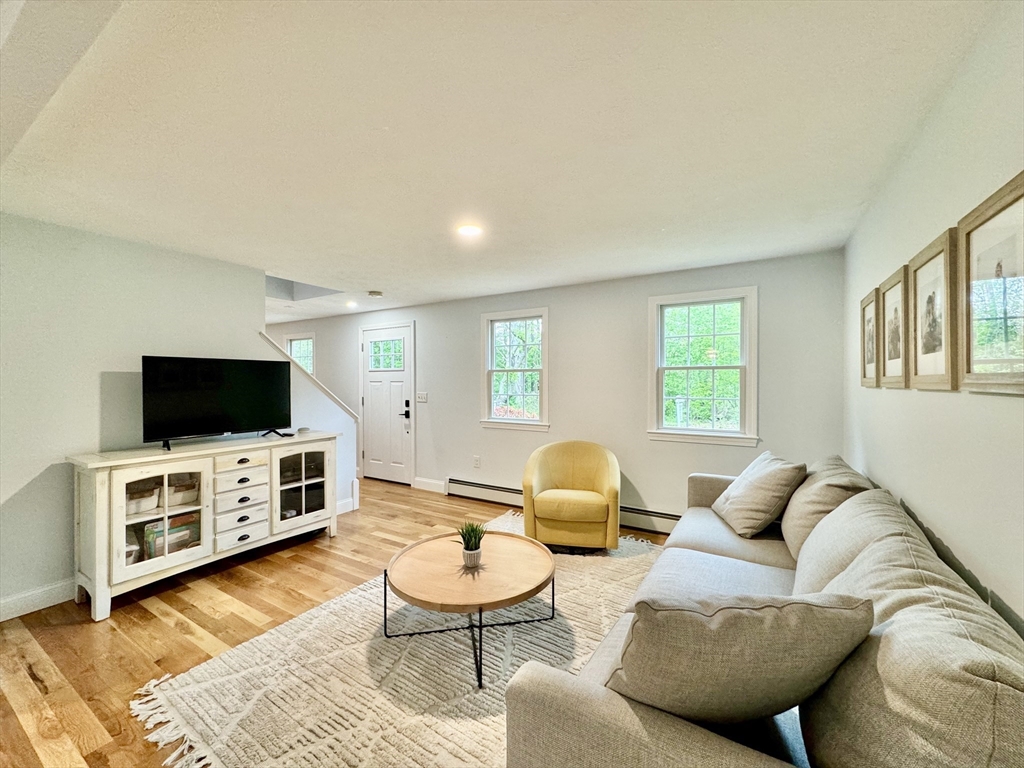 29 Whitewood Road Groton, MA 01450 - Photo 5 of 38 a living room with furniture and a flat screen tv