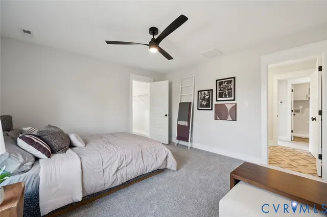 a bedroom with a bed and painting on the wall