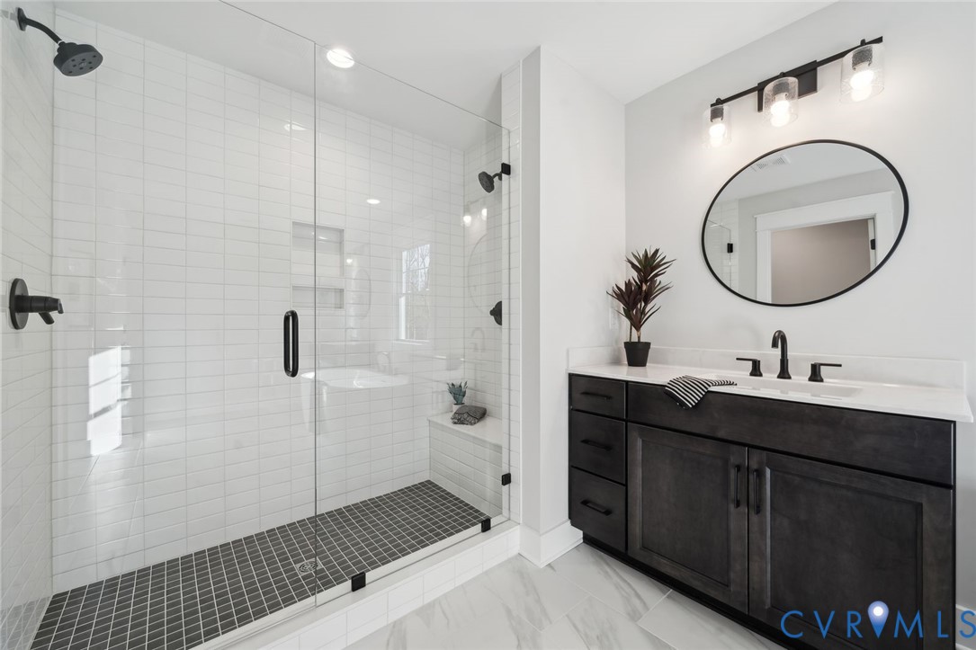 2471 Old Telegraph Road Providence Forge, VA 23140 - Photo 23 of 25 a bathroom with a double vanity sink a toilet and a mirror