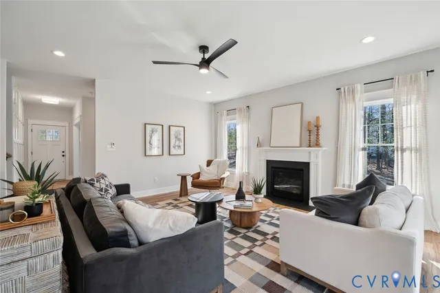 a living room with furniture and a fireplace