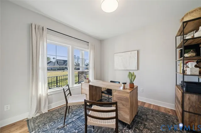 a dining room with furniture a rug and wooden floor