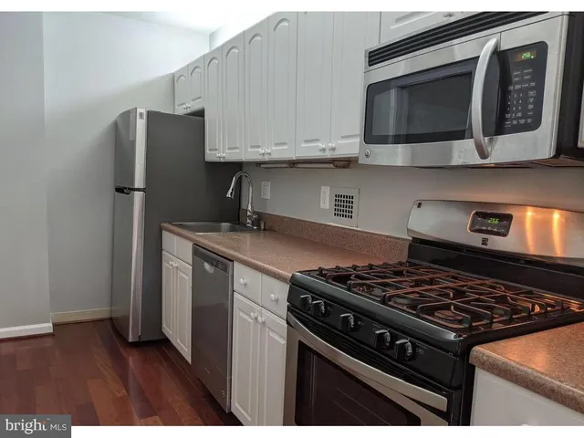 a kitchen with stainless steel appliances granite countertop a stove and a microwave