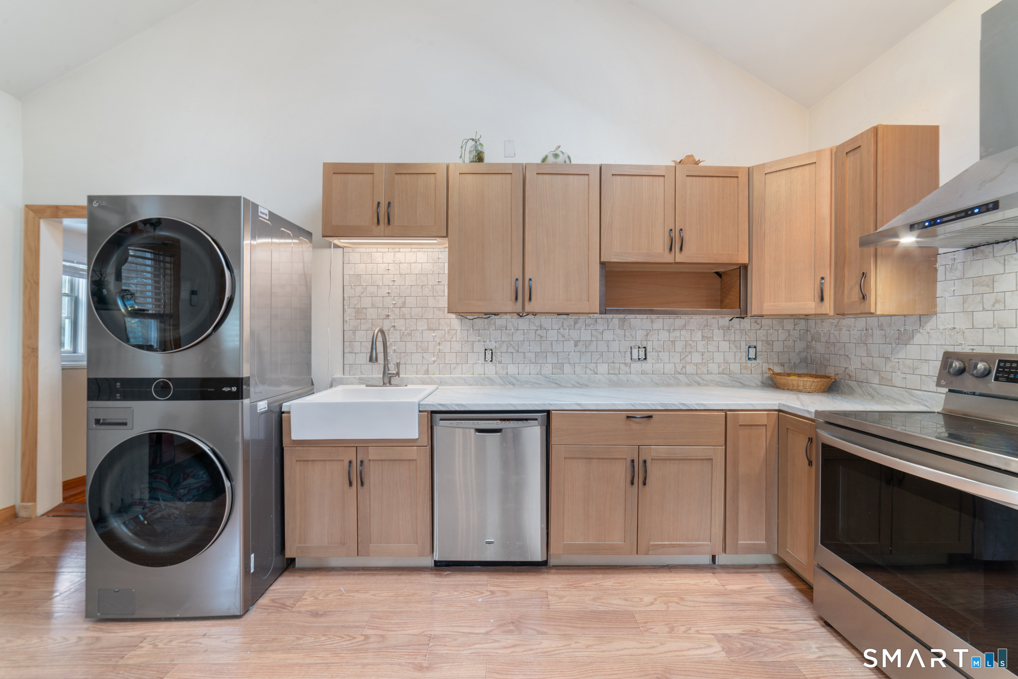 25 High Street Windsor, CT 06095 - Photo 13 of 40 a kitchen with a sink a stove and cabinets