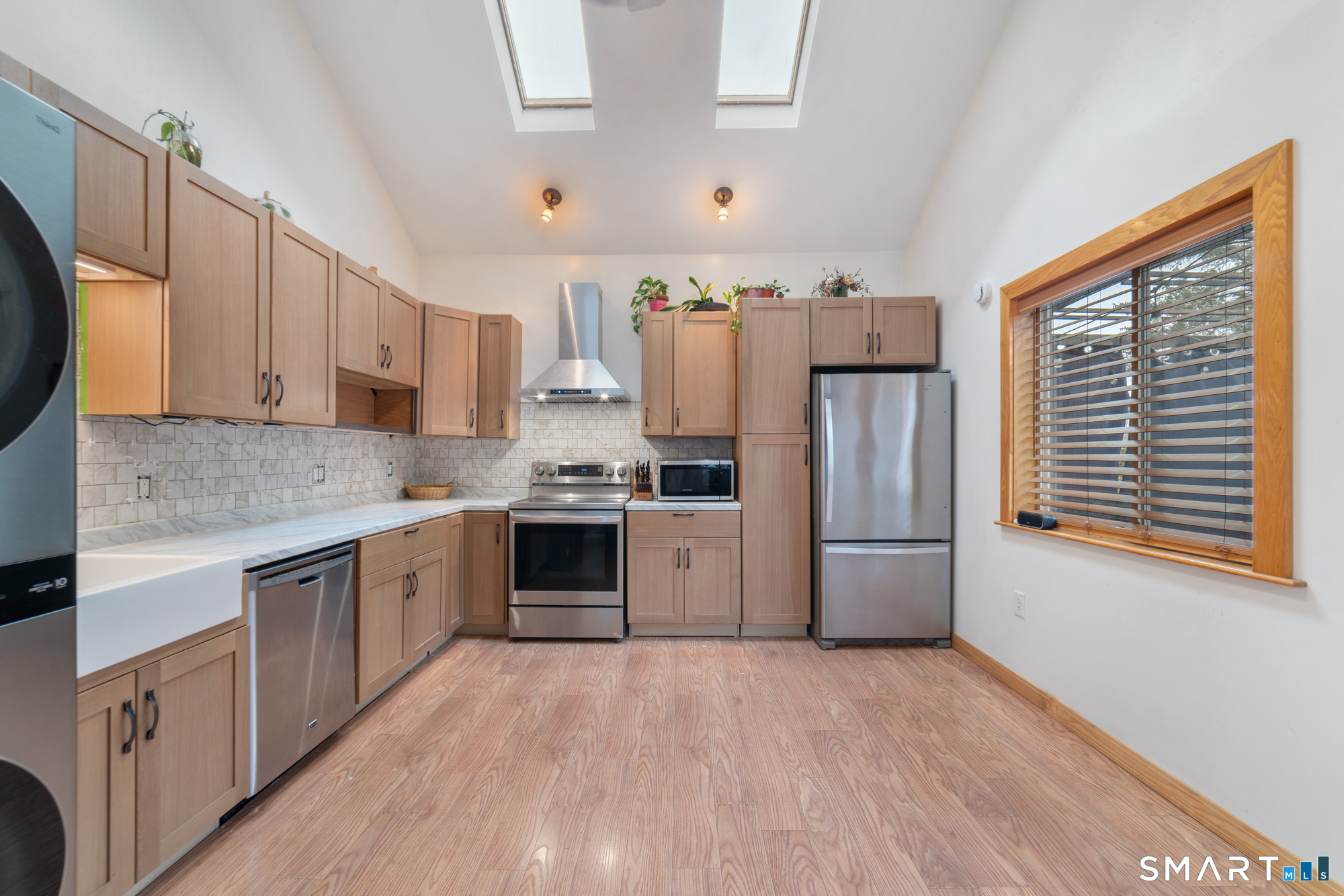 25 High Street Windsor, CT 06095 - Photo 14 of 40 a kitchen with granite countertop a refrigerator oven a sink dishwasher and white cabinets with wooden floor