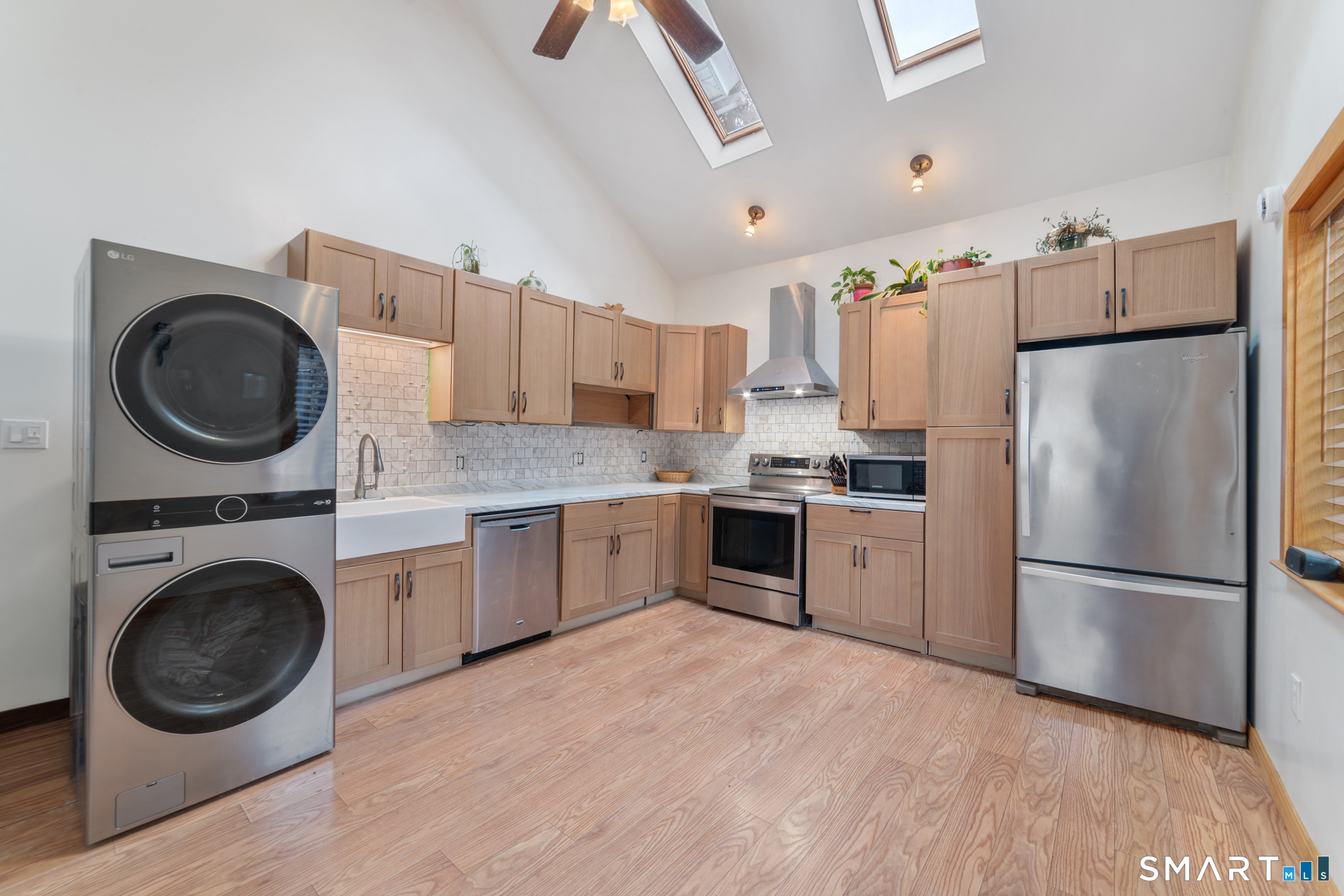 25 High Street Windsor, CT 06095 - Photo 15 of 40 a kitchen with a refrigerator sink and cabinets
