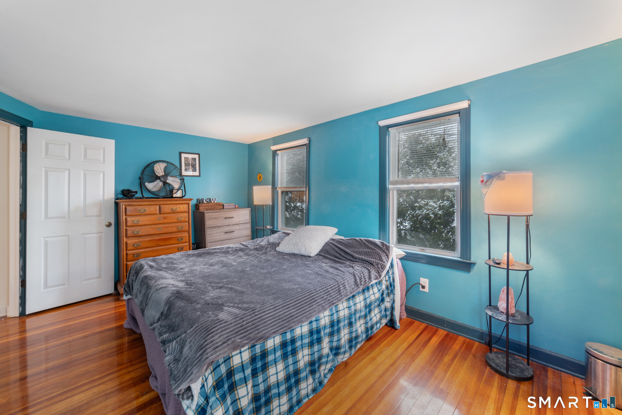 25 High Street Windsor, CT 06095 - Photo 21 of 40 a bedroom with a bed and a lamp on table