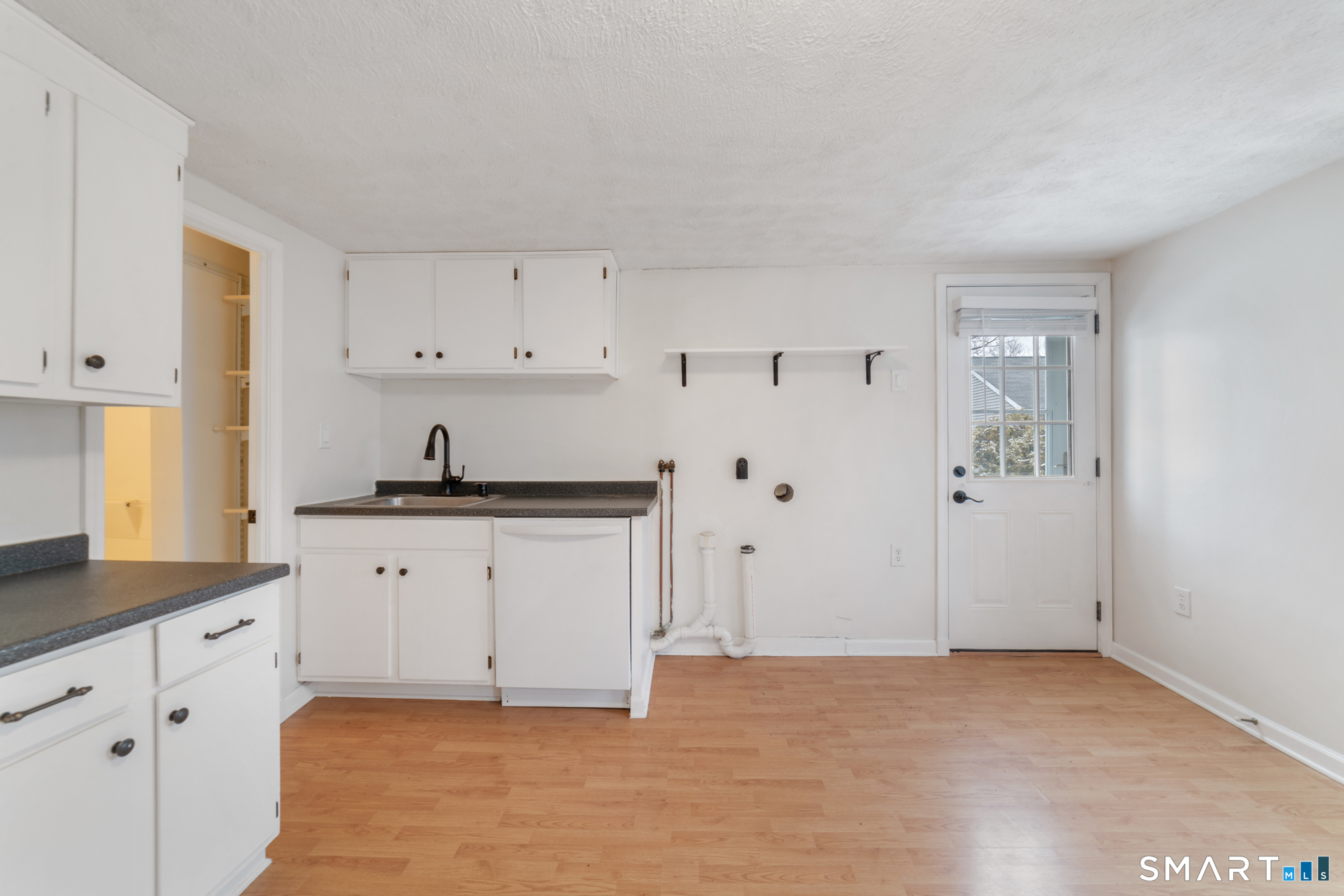 25 High Street Windsor, CT 06095 - Photo 22 of 40 a kitchen with granite countertop white cabinets and stainless steel appliances