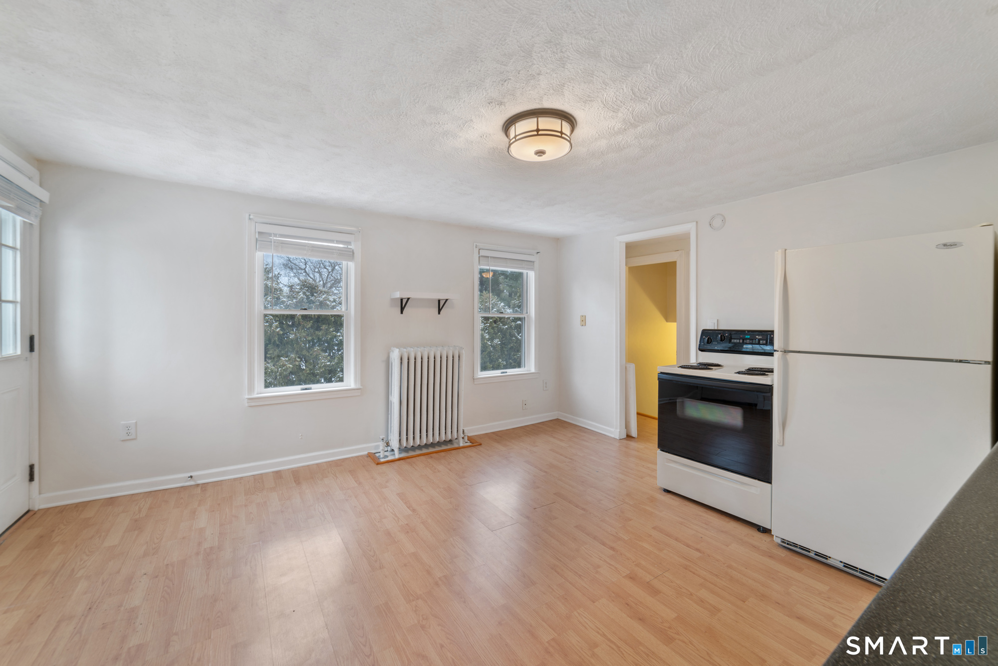 25 High Street Windsor, CT 06095 - Photo 23 of 40 a view of empty room with kitchen and window