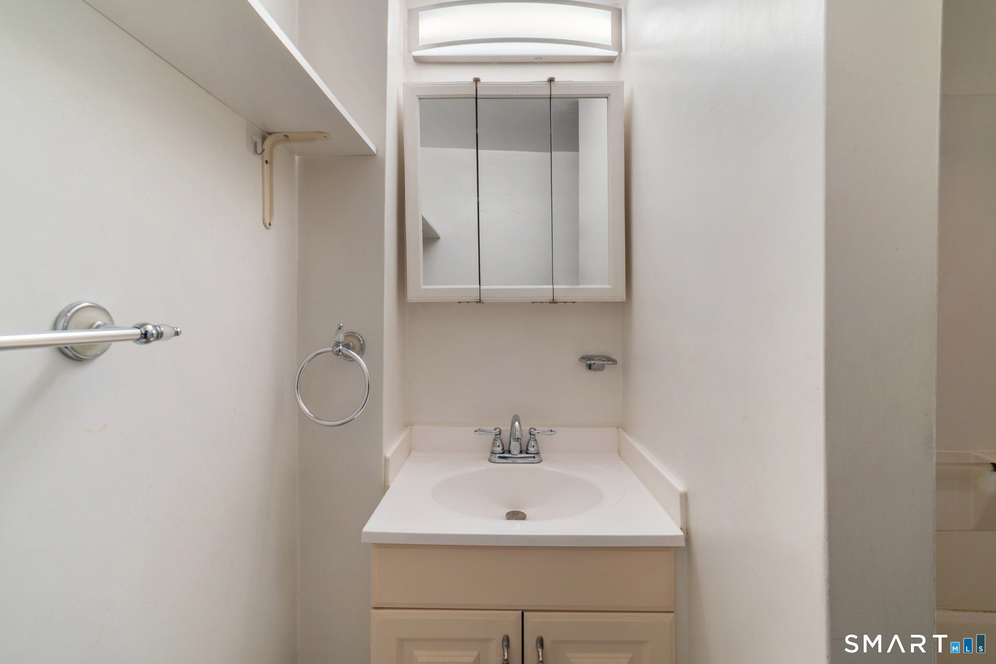 25 High Street Windsor, CT 06095 - Photo 28 of 40 a bathroom with a sink a toilet and mirror