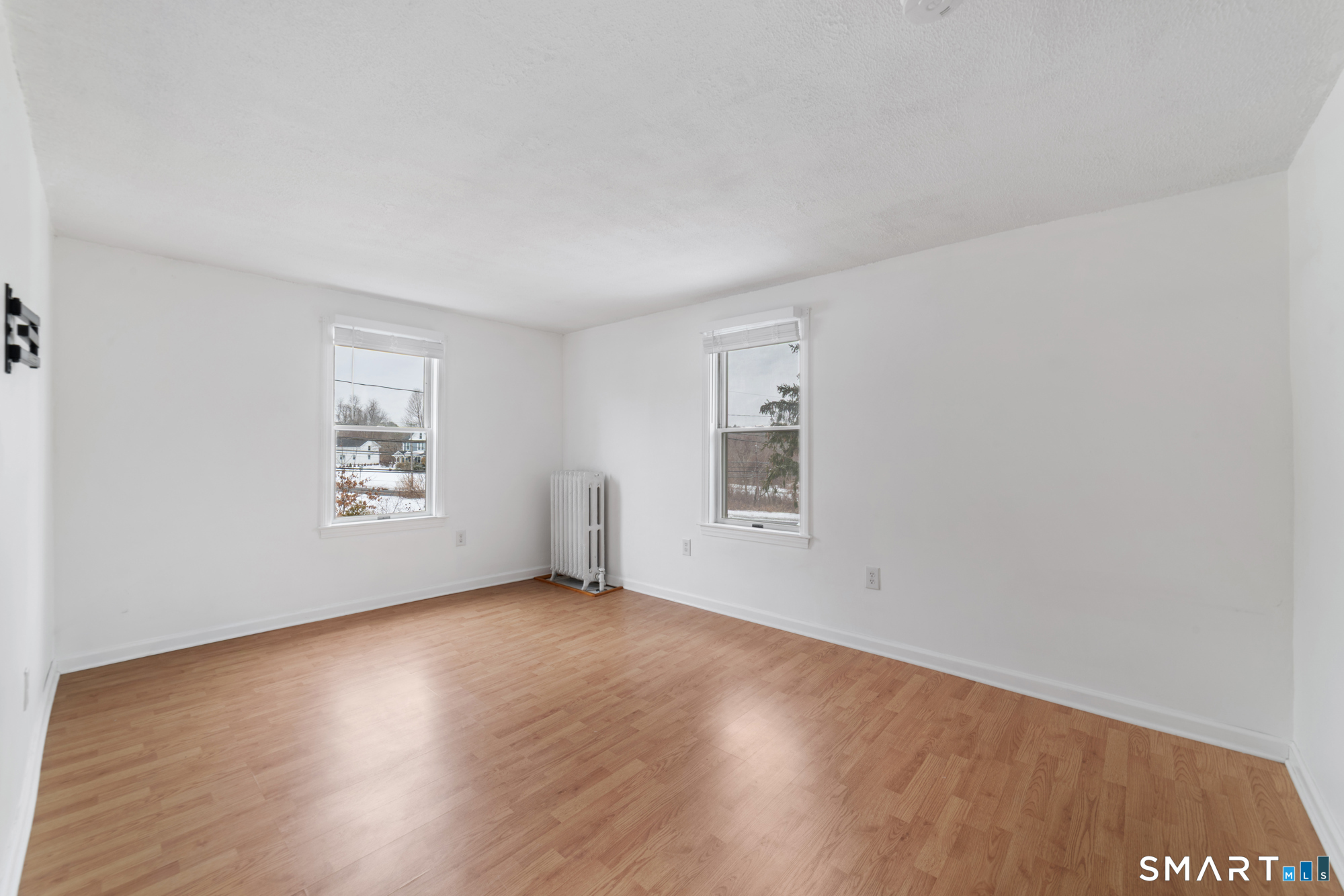 25 High Street Windsor, CT 06095 - Photo 3 of 40 an empty room with wooden floor and windows