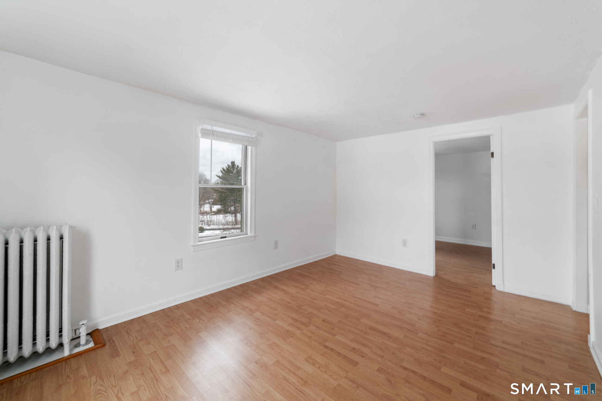 25 High Street Windsor, CT 06095 - Photo 5 of 40 an empty room with wooden floor and windows