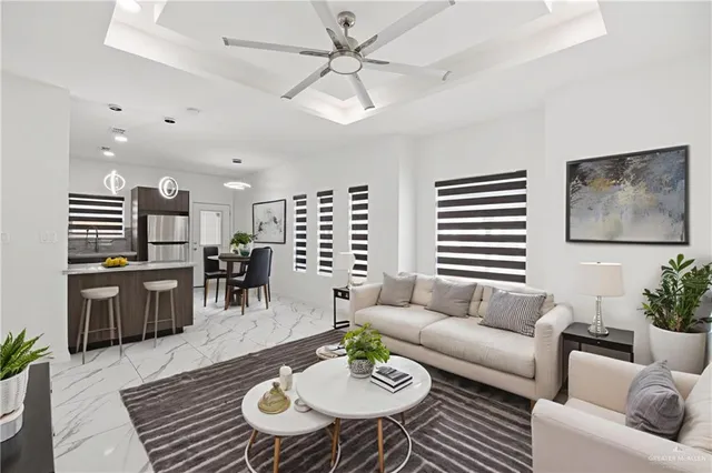 a living room with furniture kitchen view and a table