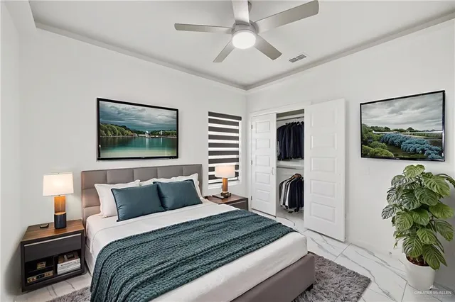 a bedroom with bed and a flat screen tv