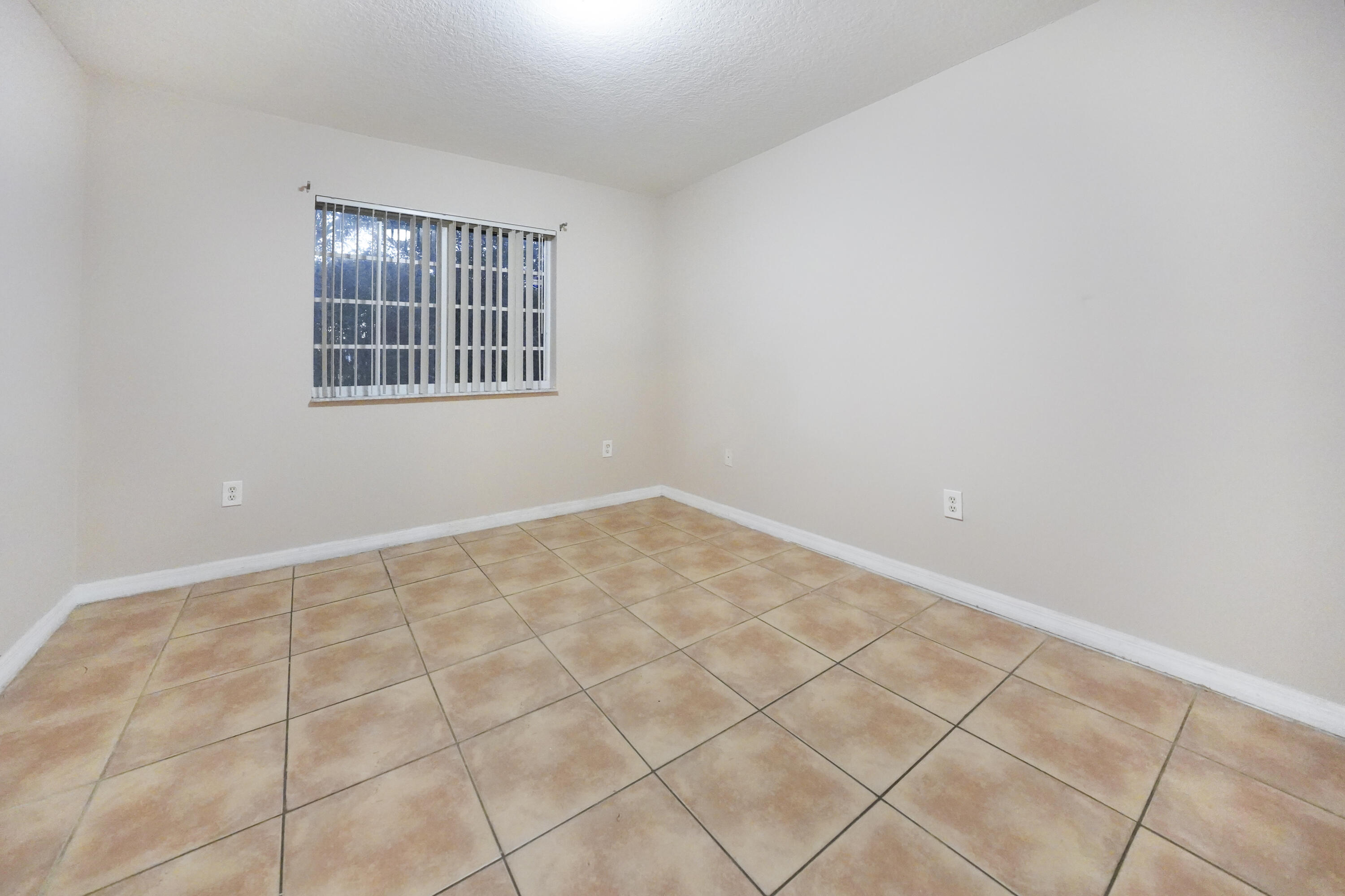 14142 Southwest 260th Street, Unit 105 Homestead, FL 33032 - Photo 11 of 17 an empty room with windows