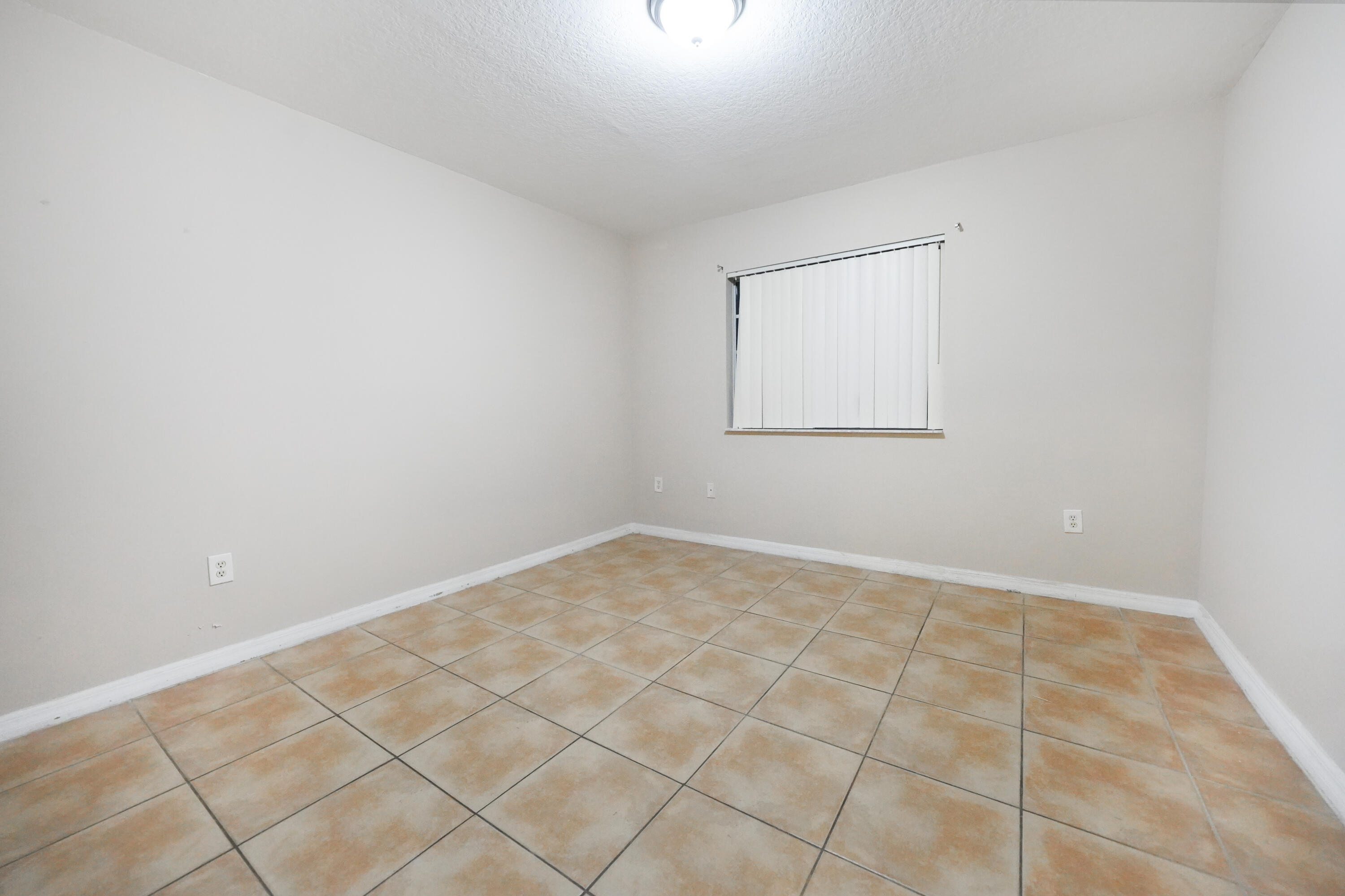 14142 Southwest 260th Street, Unit 105 Homestead, FL 33032 - Photo 12 of 17 an empty room with white walls