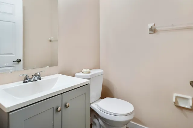 a bathroom with a sink a toilet and a mirror